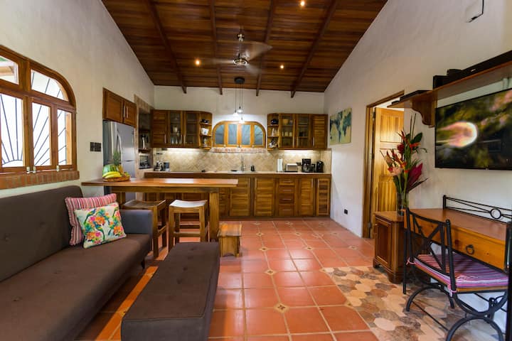 Inside the main living space you will find a comfortable sofa and ottoman facing our flat screen tv hung above our desk in the cozy office area. 