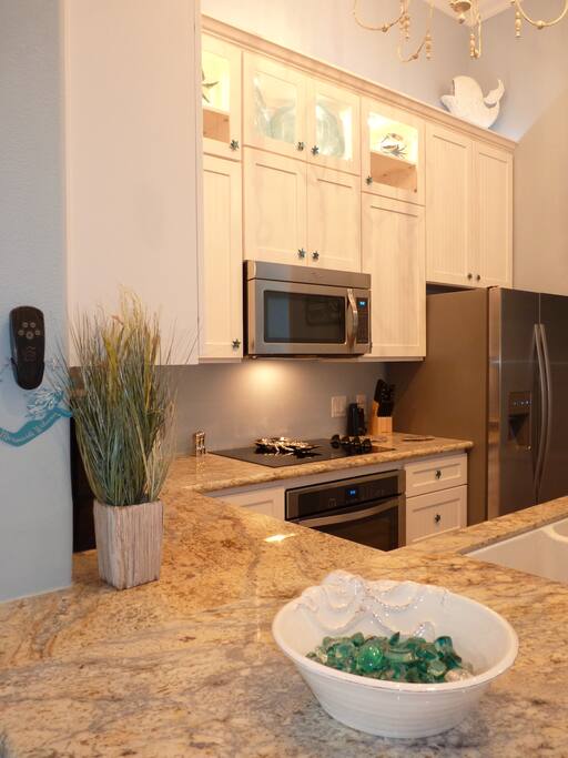 Granite counters and stainless appliances make this fully stocked kitchen a dream!