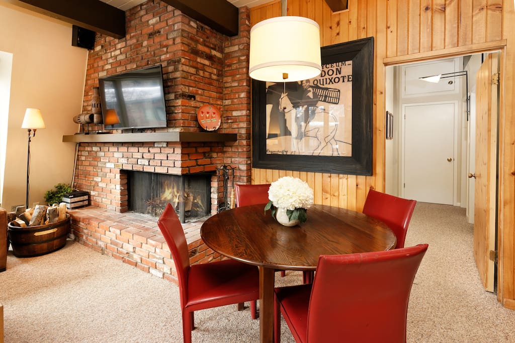 Dining table with leather chairs that can expand to seat 6.