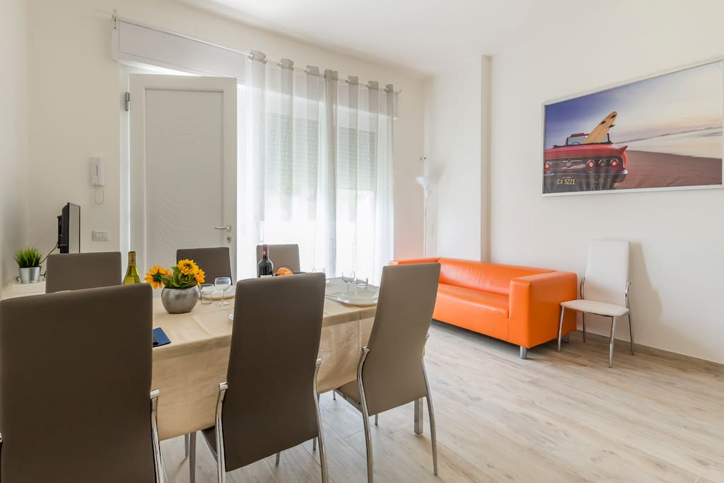 Living room with sofa, dining set and flat screen television