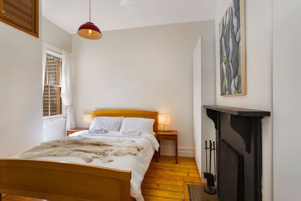 Bright, airy bedroom with fireplace and original painting "Eucalyptus" by Melbourne artist Beth Hulme