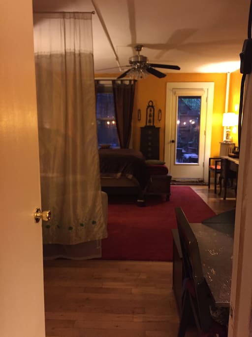 Alternate view: bedroom entry looking west toward door to the garden. Writing desk on right. (Not shown: washer/dryer and clothes closer on left)