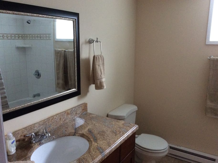 Full bath with granite countertop, tile bath and floor.