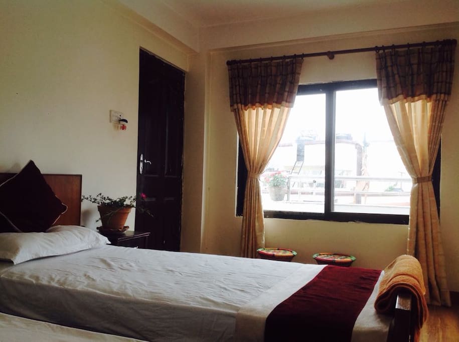 Window and your Bed with the view of High Hill's in Kathmandu