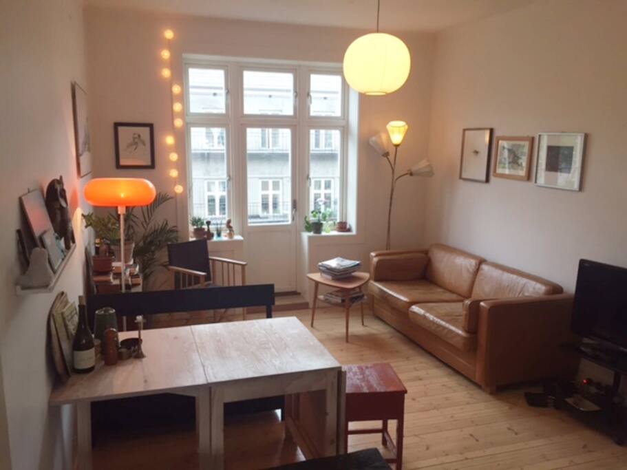 Living room with dining table and access to balcony