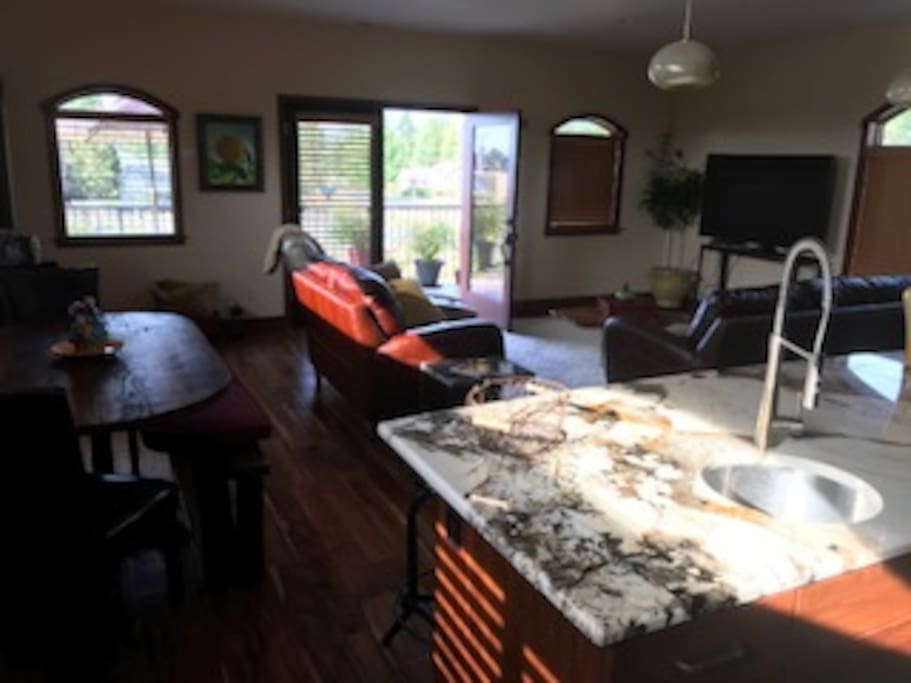 View from kitchen to living area fireplace and flat screen T.V.