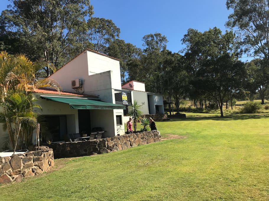 View of the villa showing the rear patio area and electric shade sail