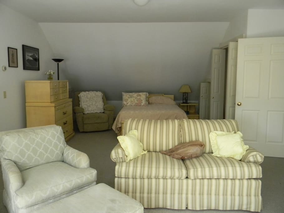 View of queen bed from living room area