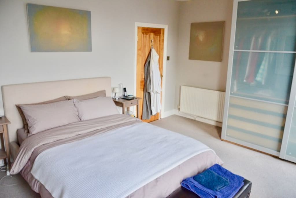 Large bright bedroom, king size bed, blackout curtains and desk