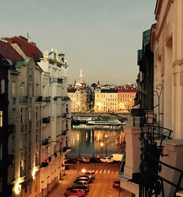 Night view to the Vltava river and Žižkov Tower at the back