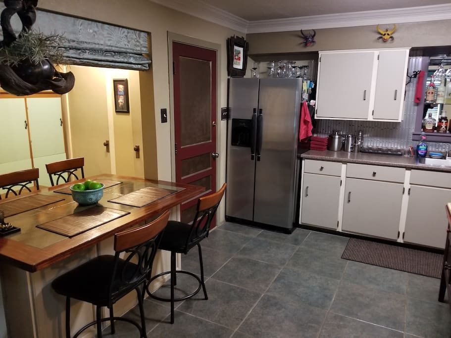 Kitchen: Open, artistic, with a Dining Table, fridge (filtered H20.Ice),Microwave,Pre-washing Dishwasher, Fully stocked with dishware/cups/Tea&Coffee .