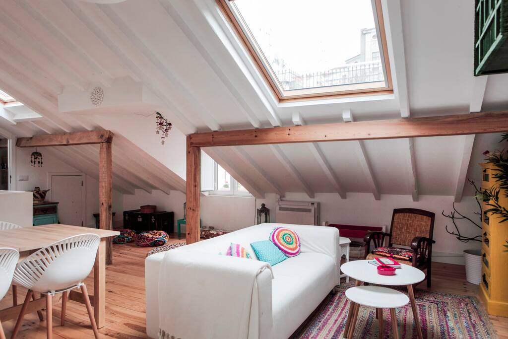 Living room with a comfortable sofa to relax watching TV or just chat and plan what will visit tomorrow. If you look at the sky you can see the view of the castle.
