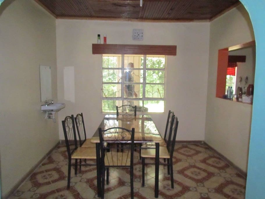 The dining room, which has a window into the kitchen.