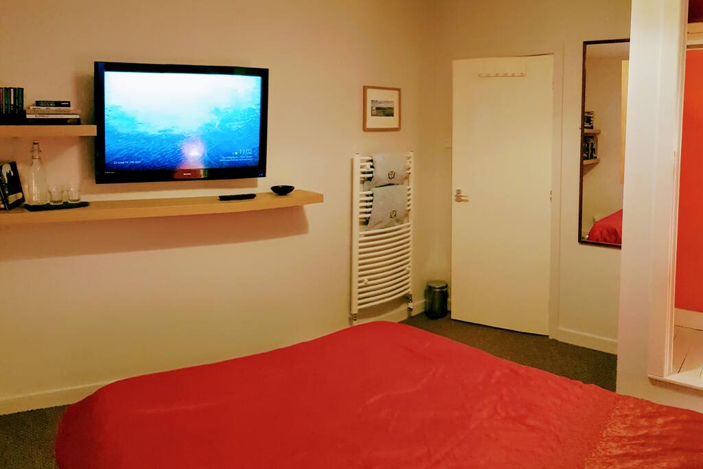 Large screen TV with Freeview and Chromecast. Towels warming on the radiator.