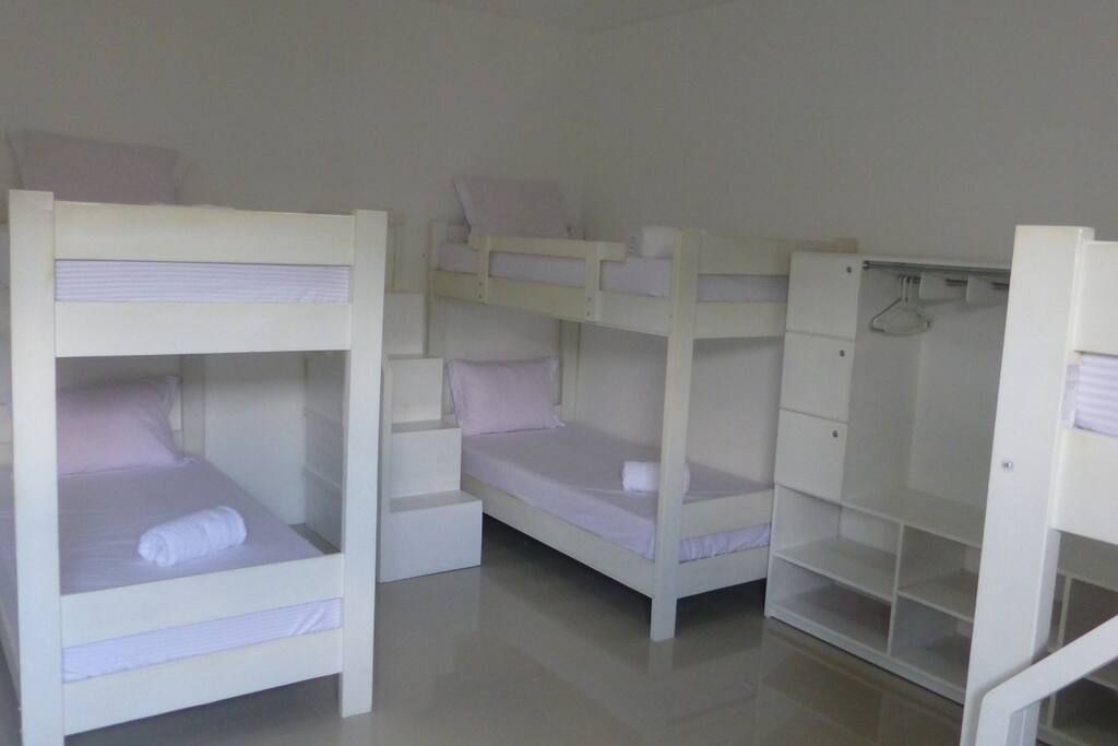 Each has a individual bed with clean, white linens, pillow, blanket and a towel
