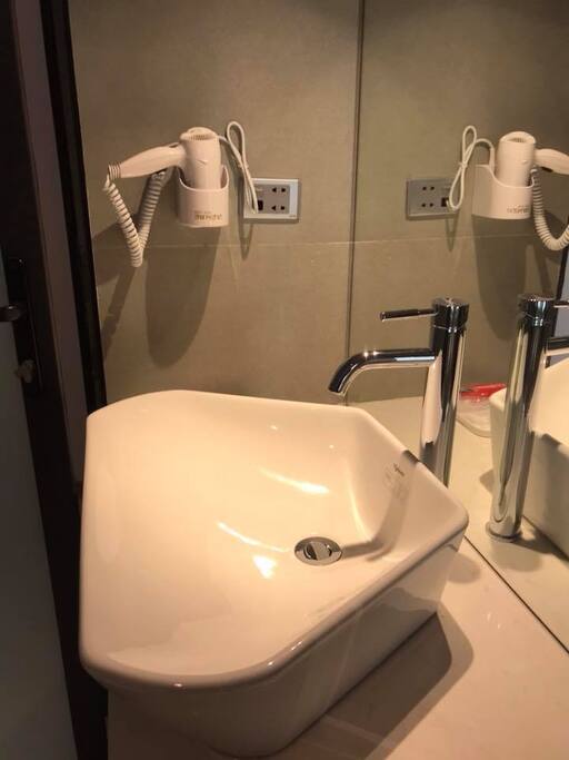 The bathroom with a big lavabo and hot water 24/7. Hairdryer is in the bathroom. Big mirror and modern shower.