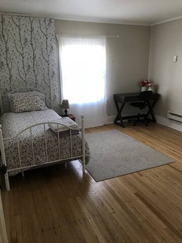 Sunny bedroom with shared bath for ladies