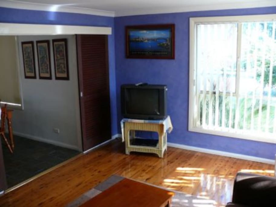 Lounge room, looking out towards the street, dining room (and kitchen) on left. NOTE - THESE PHOTOS ARE *OLD*. NEW PHOTOS COMING SOON.