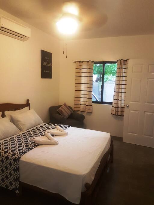 bedroom with ensuite bathroom and A/C