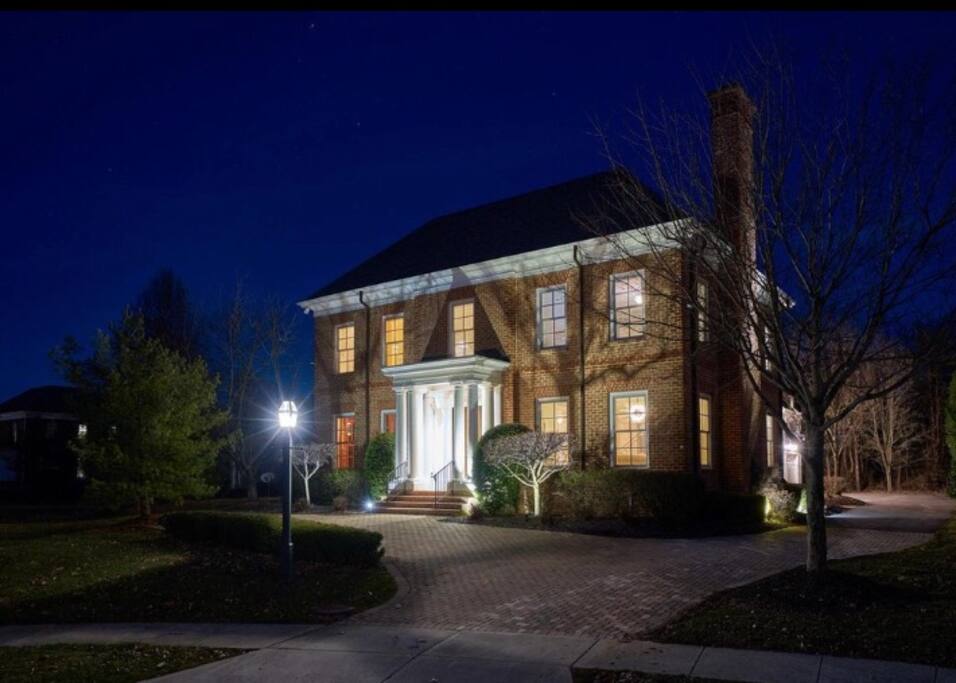 Stunning dusk view of front of estate.