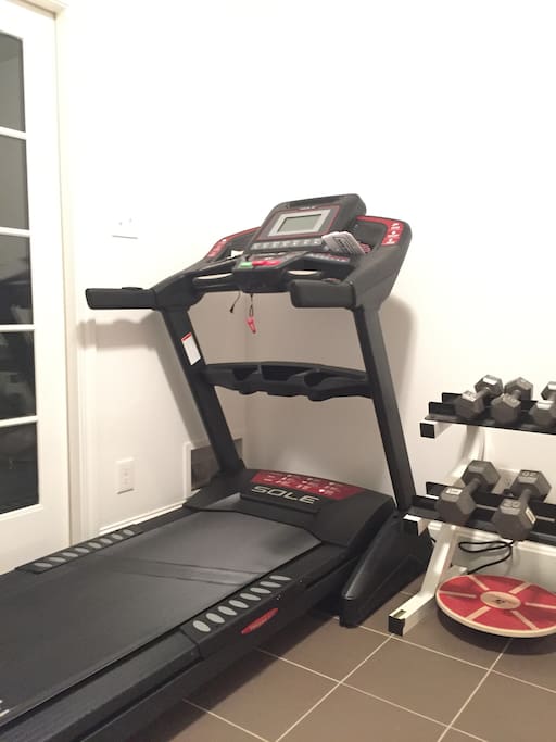 Downstairs entryway has workout equipment.