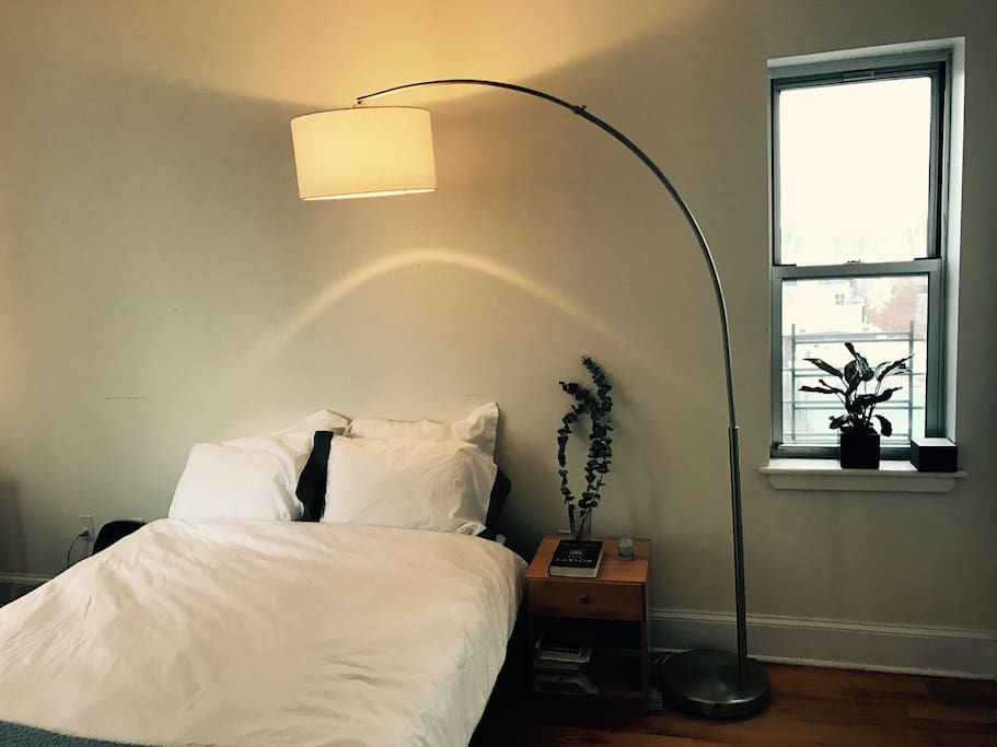 This is your bedroom, with a big queen-sized bed, fresh linens and some plant-life.