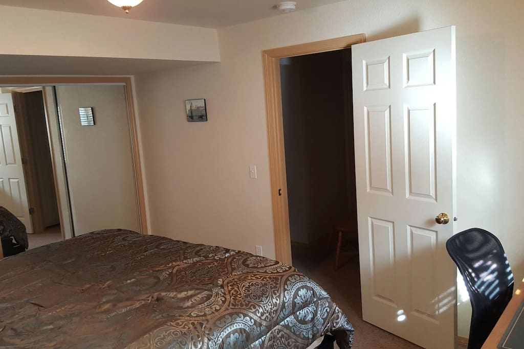 There is a desk in the corner to the right of the picture
