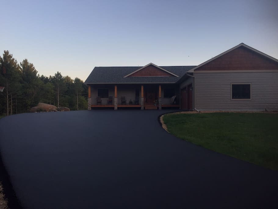 The front porch has 4 rocking chairs and offers a beautiful view down the drive way. The drive way also has a basketball hoop.