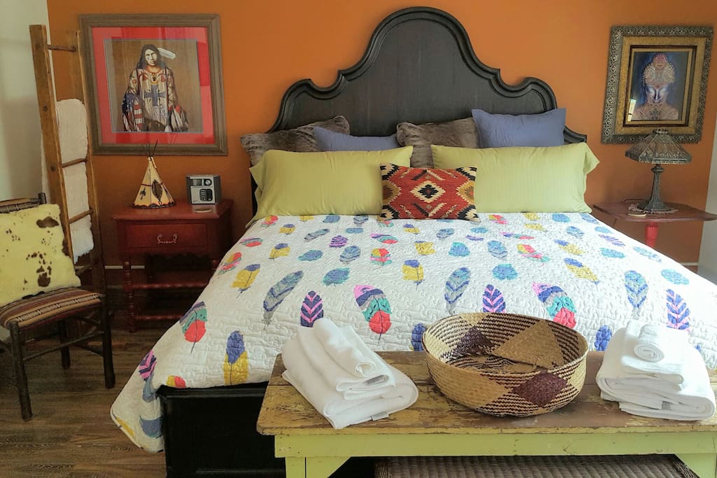 beautiful king bed with a ladder with blankets for cold nights. A teepee light flickers for mood lighting.The floors are tiled so cool in the summer!