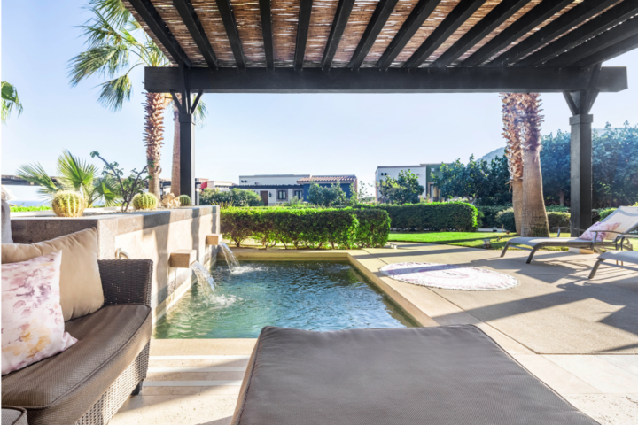 Akin to its own private compound. The backyard space—and pool—of this Los Cabos getaway is expansive yet inviting. With palms nestled throughout the yard along with a canopy and shaded lounge area, stepping into the backyard of this Airbnb home is like stepping into a private oasis.