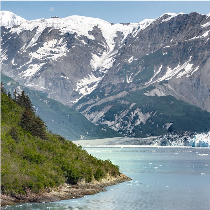 A gorgeous view of an Alaskan glacial lake in front of majestic mountains.