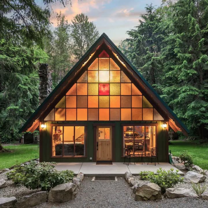 A stunning A-frame cabin with massive stained glass windows. 
