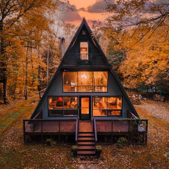 A 3-story A-frame cabin nestled in an autumnal wonderland. 