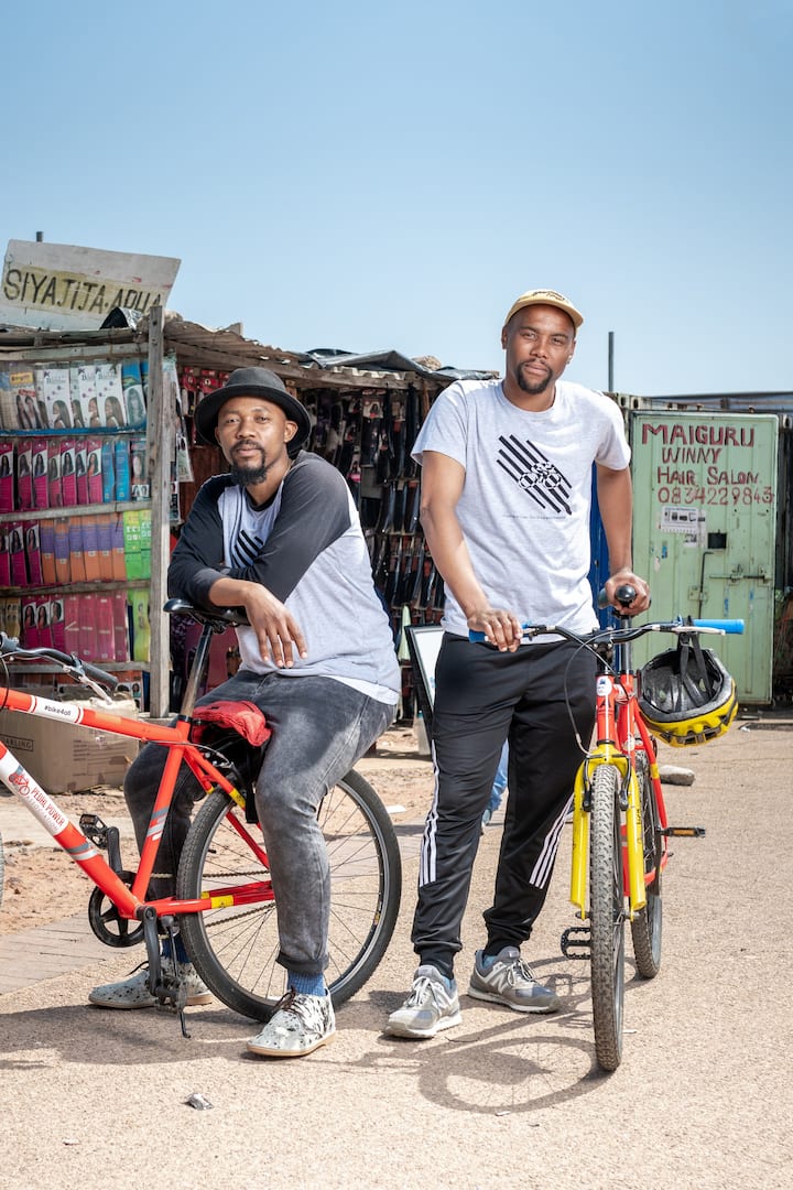 Two Airbnb Hosts look at the camera