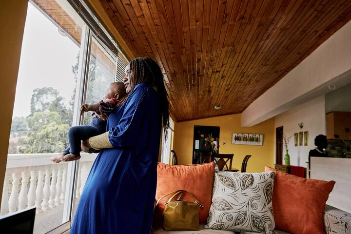 Guests looking out the window of their Airbnb listing