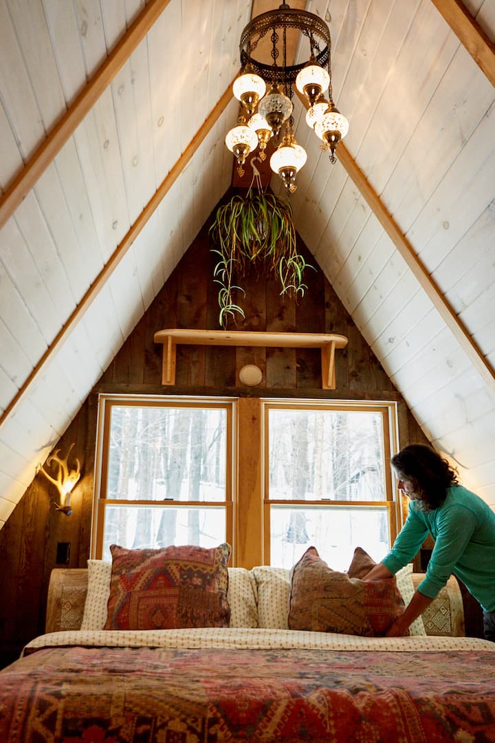 Host making bed in home