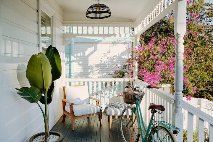 Front porch in Australia . It is sunny and  the porch has a bicycle and inviting chair