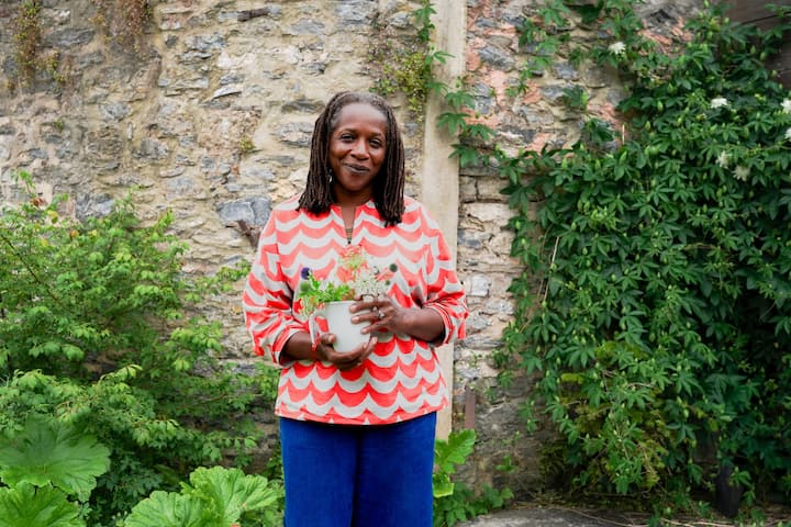 Patricia in her garden holding flowers