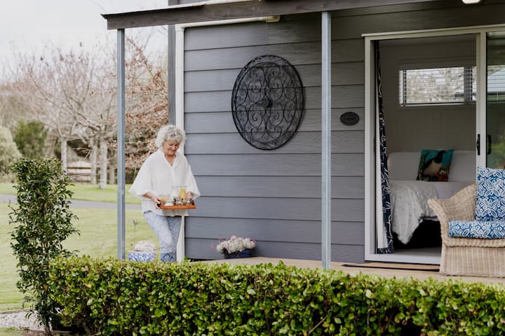 an older woman carrying breakfast supplies to the airbnb 
