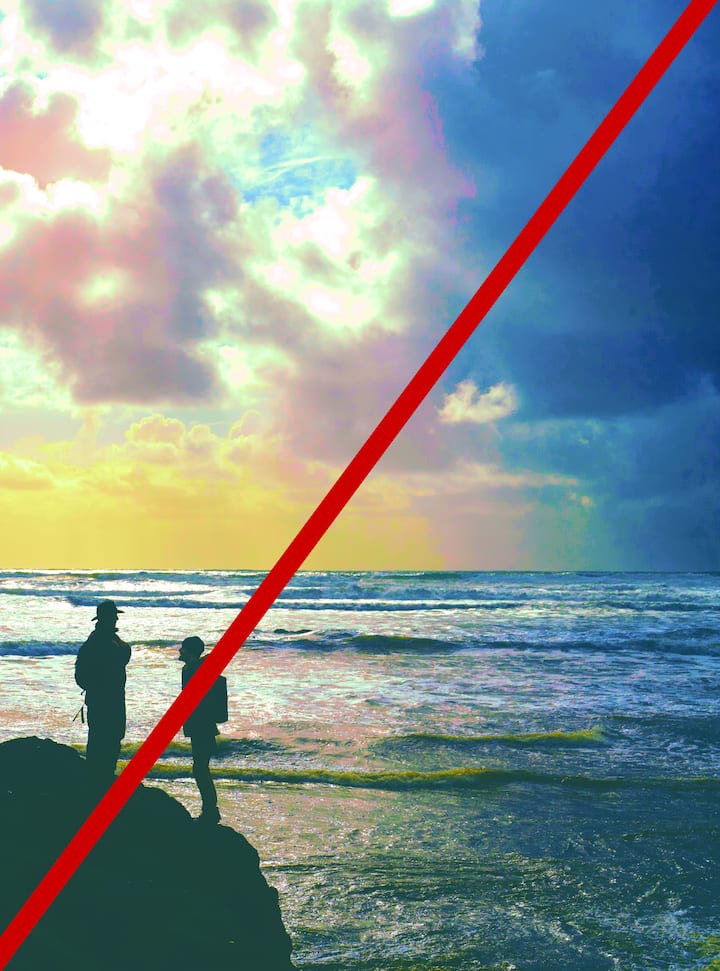 Silhouettes of two people on a rock at the beach with a vibrant sky, split diagonally by a red line. Image indicating a retouched image with heavy filters applied that would be rejected.
