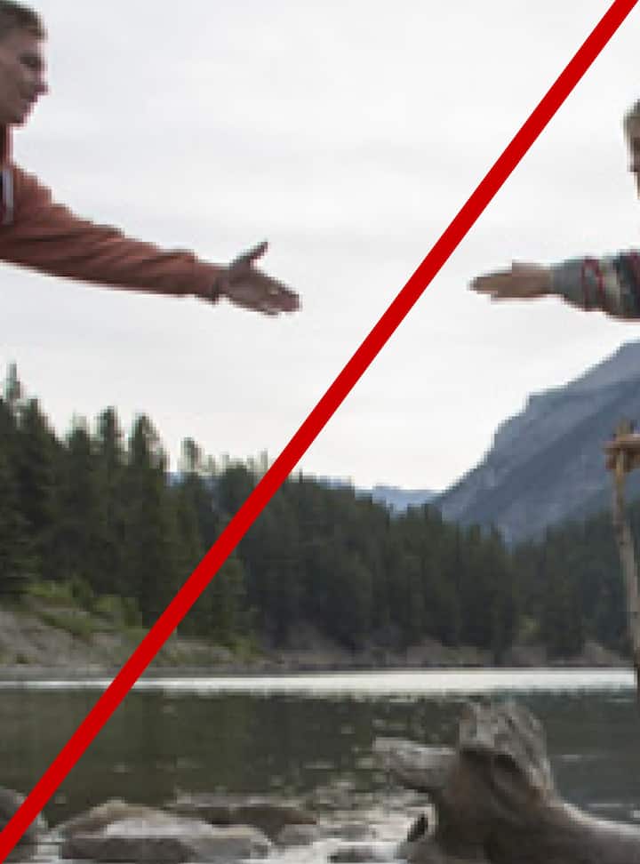 Two people reaching out to each other across a lake with mountains and a forest in the background. Image is cropped in on an area without enough information. The image has a red line indicating the image would be rejected.
