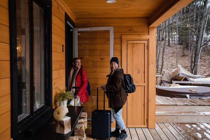 2 women with suitcases checking into a cabin during off-season