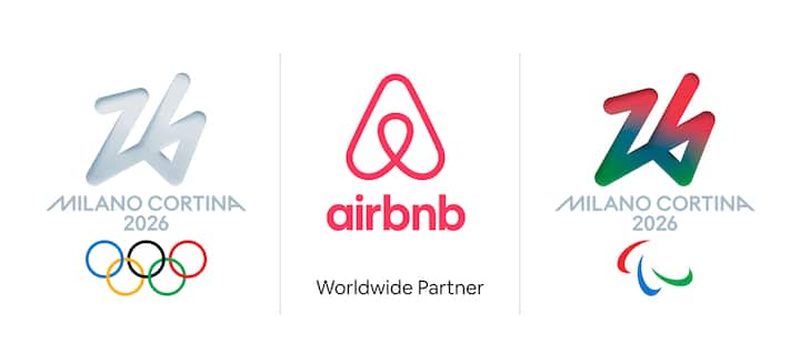 Airbnb logo in the center, flanked by Milano Cortina 2026 Winter Olympics logo on the left and Paralympics logo on the right.