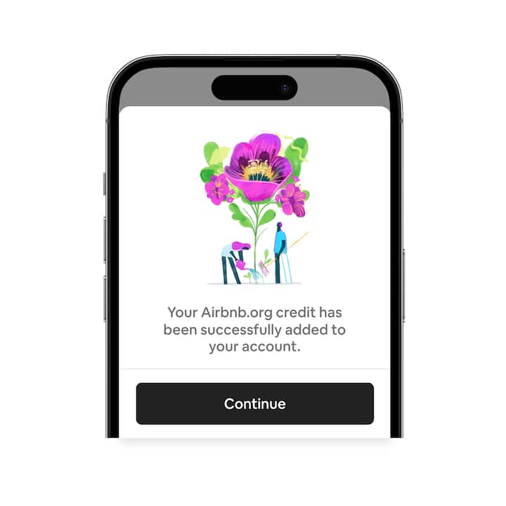 Phone screen with a pop-up window affirming that Airbnb.org credit is in your account and a black button that says “Continue”