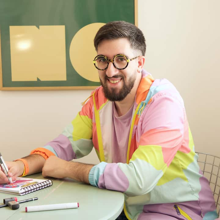 Arturo Blas inside his listing writing at a table