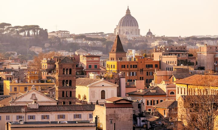 View of Rome's skyline featuring St. Peter's Basilica and surrounding architecture, part of Airbnb's responsible tourism campaign in partnership with the Vatican for the 2025 Jubilee.