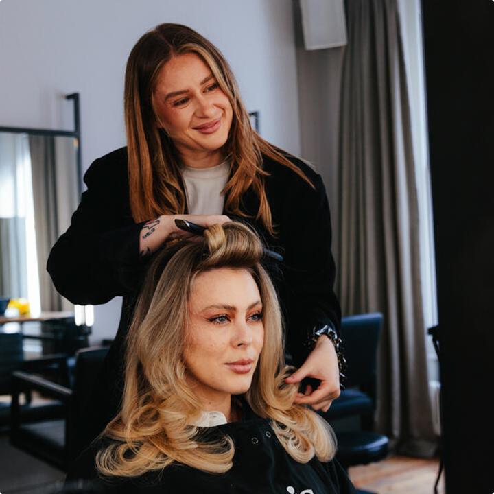 A hair stylist working on a client's hair, showcasing a beauty service in a salon environment.