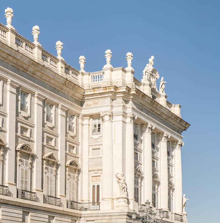 Close-up view of the ornate facade of a historic European building under a clear blue sky.