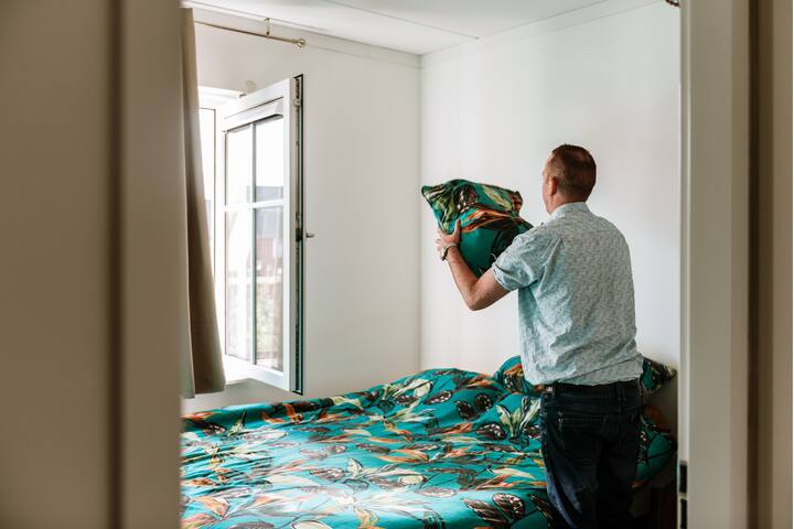 Host doing cleaning in a bedroom