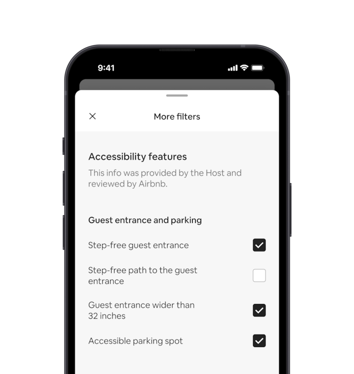 A mobile phone displays the More filters overlay, which is one of many search filters. There is a section heading that reads “Accessibility Features.” Below that accessibility features are grouped by areas like “Guest entrance and parking.” There are checkboxes where you can select as many features as you want.